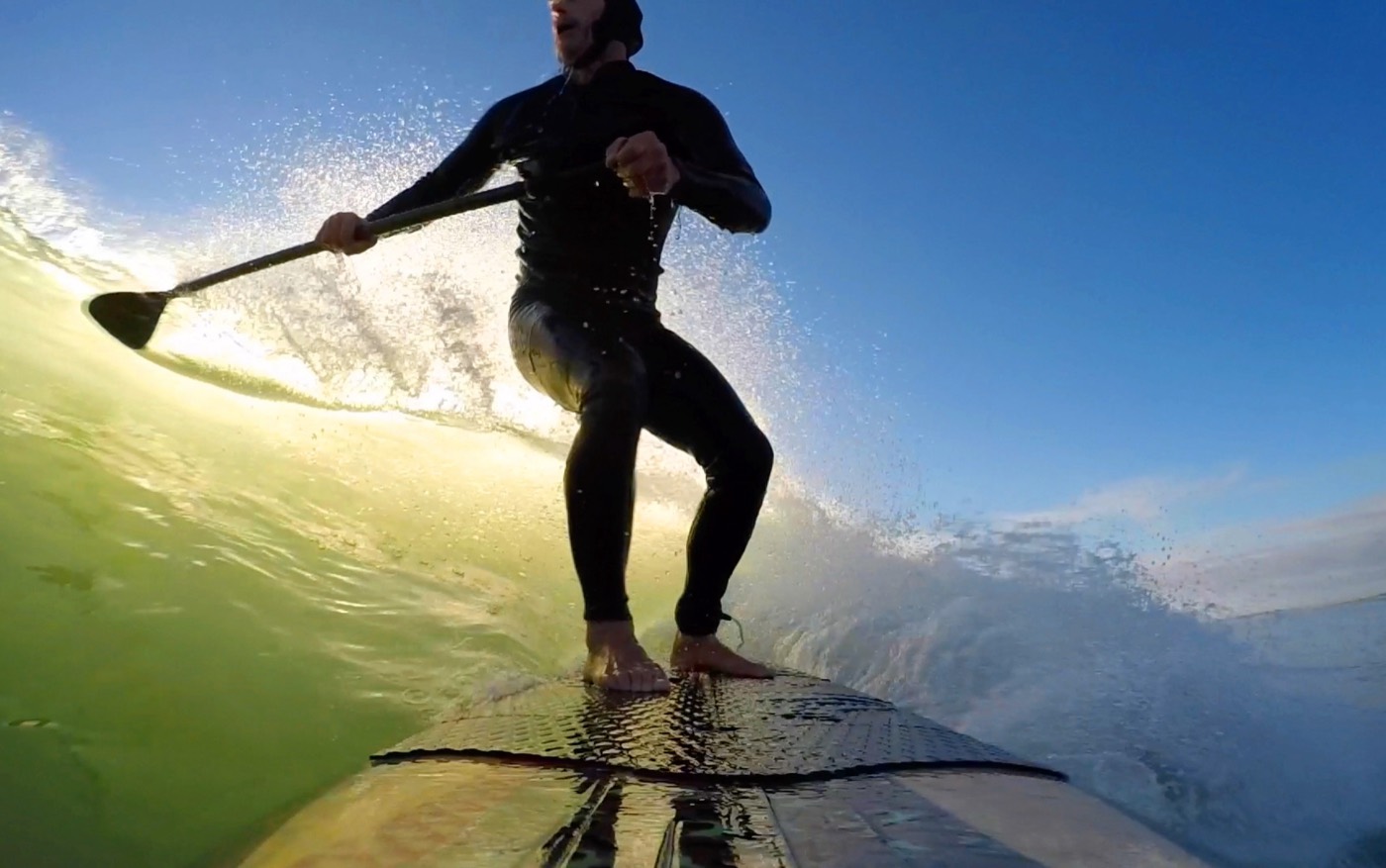 A paddleboarder crossing open water